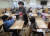 지난 2일 오전 대구 동구 봉무초등학교 3학년 교실에서 담임교사가 학생들에게 코로나 자가 진단키트를 나눠주고 있다. [연합뉴스]