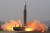 북한이 24일 김정은 국무위원장의 현장지도로 신형 대륙간탄도미사일(ICBM) '화성-17'형 미사일을 발사하고 있다. 북한은 이날 이동식 발사 차량(TEL)에서 미사일을 기립시켜 곧바로 발사해 발사 신을 단축했다. [뉴스1]