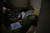 마리우폴 여성이 28일 불이 꺼진 자신의 집에 누워 있다. TASS=연합뉴스