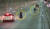 지난 2월 충남 보령해저털에서 주행 중이던 차량에서 내린 동승자들이 기념 사진을 찍고 도로를 달리고 있다. [사진 충남경찰청]