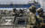 러시아 군인들이 지난달 29일 우크라이나 남부 항구도시 마리우폴에서 경비를 서고 있다. EPA=연합뉴스