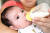  미국의 20대 엄마 유리 나바스가 지난 23일 생후 2개월 아기에게 분유를 타서 먹이고 있다. 나바스는 "분유가 모자라 간혹 밥물을 줬다"고 했다. [AP=연합뉴스] 