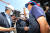 이정식 고용노동부 장관(가운데)과 김형수 조선하청지회장이 지난 19일 점거 농성 중인 대우조선해양 1도크에서 만나 악수하고 있다. [뉴스1]