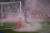 리버풀의 선제골 직후 리버풀 서포터가 그라운드로 던진 홍염에서 붉은 연기가 피어오르고 있다. [AP=연합뉴스]
