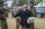 9일(현지시간) 선거 당일 한 유권자가 "먹을 게 없으면 선거도 없다"는 손팻말을 들고 시위를 하다 경찰에 연행됐다. AP=연합뉴스