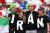 국가 이름이 새겨진 티셔츠를 나눠 입은 이란 축구 팬. AFP=연합뉴스