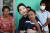 윤석열 대통령 부인 김건희 여사가 12일 캄보디아 프놈펜에서 선천성 심장질환을 앓고 있는 14세 아동의 집을 찾아 아이를 안고 있다. 뉴스1