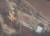 북한 평안북도 철산군 동창리 서해위성발사장의 발사대 일대를 촬영한 12월 1일 자 위성사진. 발사대 남쪽 구조물에 개폐형 패널(사각형 안)이 매달려 있다. 크레인 자재로 보이는 물체(원 안)는 발사장 중심부 바닥에 놓여 있다. VOA 화면 캡처