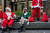 지난 10일(현지시각) 산타 복장으로 술을 마시는 연례행사인 '산타콘' 참가자들이 맨해튼 거리에서 휴식을 취하고 있다. 로이터=연합뉴스