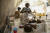 지난달 11일 아이티 포르토프랭스에서 '국경 없는 의사회'가 운영하는 병원에서 한 여성이 콜레라에 걸린 딸 주위를 맴도는 파리를 수건으로 쫓고 있다. AP=연합뉴스