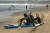 외국인 관광객들이 지난 3월 22일 인도네시아 발리의 쿠타 해변에 앉아 있다. AP=연합뉴스