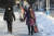 지난달 23일 북한 평양시 중심 구역의 눈 덮인 거리를 시민들이 걷고 있다. AP=연합뉴스