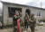 우크라이나 동부 이지움의 병영에서 24일 우크라이나 군 사제가 병사에게 성수를 뿌리고 있다. EPA=연합뉴스