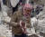 7일 시리아 진데리스에서 건물 잔해에 갇혔다 구조되는 신생아. 당시 아기는 탯줄도 떼지 못한 채 울고 있었다고 한다. [AP=연합뉴스]