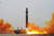 북한이 지난 18일 오후 평양국제비행장에서 이동식발사차량(TEL)를 통해 대륙간탄도미사일(ICBM) ‘화성-15형’을 발사하는 모습. [조선중앙통신=연합뉴스]