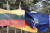 26일(현지시간) '그리핀 스톰' 연합훈련이 열린 리투아니아 파브라데 훈련장에 리투아니아(왼쪽), 독일(가운데), 나토(오른쪽) 국기가 함께 휘날리고 있다. EPA=연합뉴스