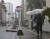 일본 미야자키현에서 9일 파손된 우산을 들고 걷는 보행자. [AP=연합뉴스]
