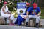 도널드 트럼프의 지지자들이 24일(현지시간) 미국 조지아주 풀턴 카운티 구치소 앞에서 트럼프 전 대통령을 지지하는 플래카드를 들고 앉아 있다. AP=연합뉴스