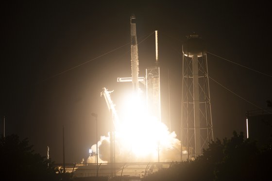 미국 플로리다주 케이프커내버럴의 케네디 우주센터에서 26일(현지시간) 우주비행사들과 함께 크루 드래곤 우주선을 탑재한 스페이스X 팰컨9 로켓이 39A 발사대에서 이륙하고 있다. AP=연합뉴스