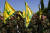 Hezbollah fighters rise their group's flag and shout slogans, as they attend the funeral procession of Hezbollah fighter, Bilal Nemr Rmeiti, who was killed by Israeli shelling, during his funeral procession in Majadel village, south Lebanon, Sunday, Oct. 22, 2023. (AP Photo/Hassan Ammar)  〈저작권자(c) 연합뉴스, 무단 전재-재배포 금지〉