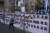 22일(현지시간) 이스라엘에서 한 시민이 하마스에 납치된 인질의 사진이 붙은 울타리 앞을 지나가고 있다. AP=연합뉴스
