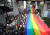 지난 6월 4일 태국 방콕에서 열린 성소수자 기념행사 'PRIDE FOR ALL'에 참가한 시민들이 커다란 무지개 색 깃발을 들고 있다. EPA=연합뉴스