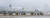 23일 강풍과 폭설로 운항이 중단된 제주국제공항 활주로에서 제설차들이 작업하고 있다. [뉴시스]