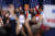 도널드 트럼프(가운데) 전 미국 대통령이 24일(현지시간) 사우스캐롤라이나 컬럼비아에서 열린 경선 승리 축하 행사 무대에 올라 지지자들이 환호하는 모습을 바라보고 있다. 로이터=연합뉴스