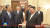 13일 평양 노동당 청사에서 김정은(앞줄 오른쪽) 북한 국무위원장이 자오러지(왼쪽) 중국 전인대 상무위원장에게 선물을 받고 미소짓고 있다. 오른쪽 아래에 중국의 국주로 불리는 마오타이 30년산 상자가 보인다.  CC-TV 캡처