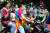 13일(현지시간) 태국 남부 나라티왓 주에서 송끄란 축제 첫날 오토바이 운전자가 시민들로부터 물세례를 맞고 있다. AFP=연합뉴스