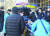 서울 강서경찰서에서 조사를 받던 오스템임플란트 직원 이모씨가 7일 어지러움을 호소해 구급차로 옮겨지고 있다. [연합뉴스]