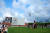 홍콩 서구룡문화지구 M+앞 아트 파크에서 공연된 프랑스 안무가 라시드 우람단의 ‘줄 긋는 자들’. 정면의 건물 M+에 ‘댄스 리플렉션’ 대형 포스터가 걸려 있다. [사진 반클리프 아펠]