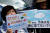 25일 일본 도쿄의 총리 관저 앞에서 한 시민이 후쿠시마 원전 오염수의 해양 방류를 중단하라는 문구가 적힌 푯말을 들고 시위를 벌이고 있다. [로이터=연합뉴스]